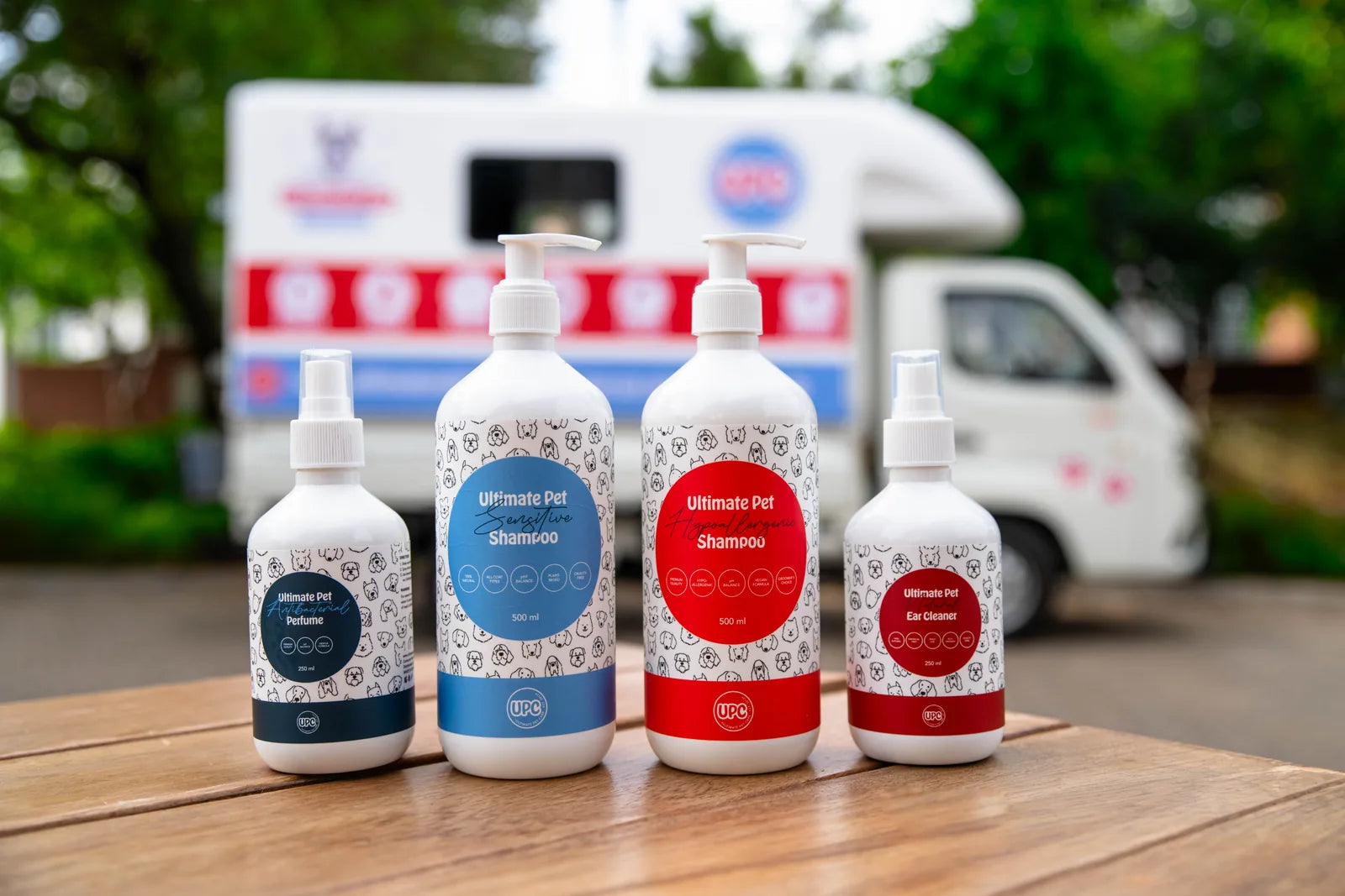 Ultimate Pet shampoos, perfume and ear cleaner in front of the UPC grooming van